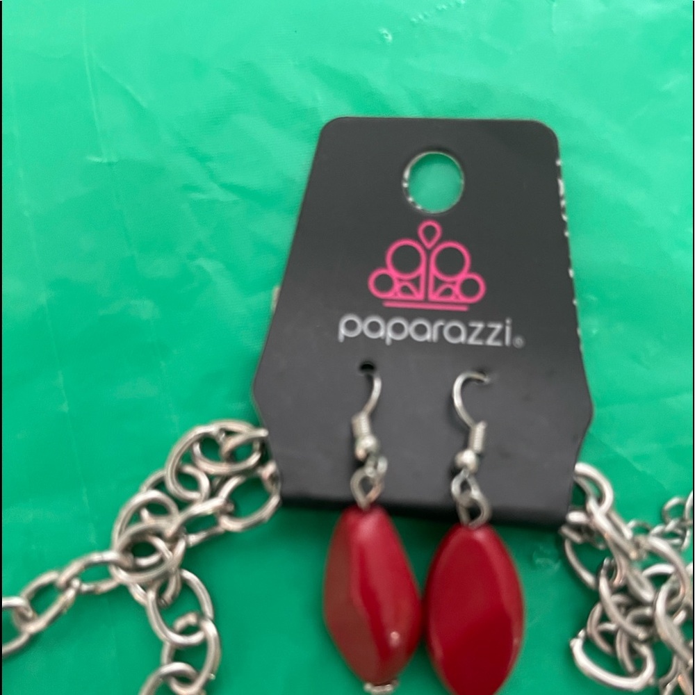 Silver chain necklace set with red accents.